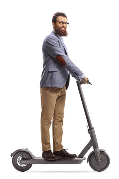 istock Beared man riding an electric scooter and looking at camera 1313156584