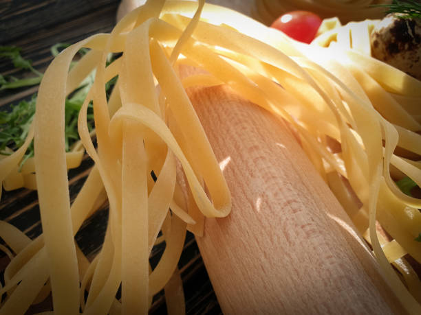 raw pasta, quail egg on a wooden background