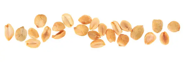 Salted roasted peanuts isolated on a white background, top view. Spicy peanuts pile.