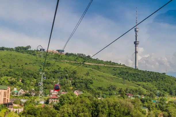 Cable car leading to Kok Tobe mountain above Almaty, Kazakhstan. Almaty Television Tower visible.