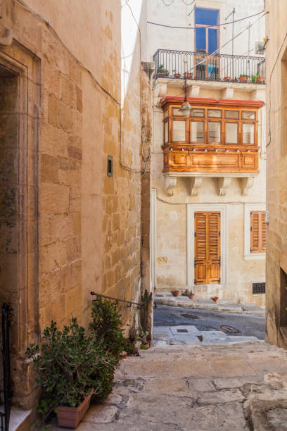 istock Typical narrow street in Birgu town, Mal 1313162677