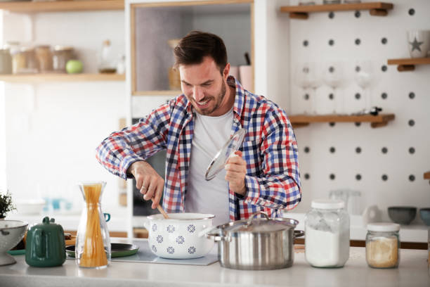 istock Smiling young man in kitchen. stock photo 1313165005