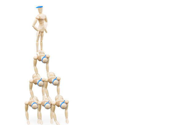 A drawing doll that stands proudly on a human pyramid with a headband