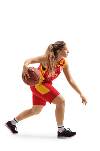 Female basketball player leading a ball isolated on white background