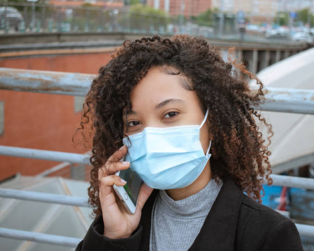 istock Woman wearing a mask in a phone call. 1313166675