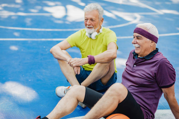 istock Two active senior men on basketball field taking a break from sport activity 1313168069