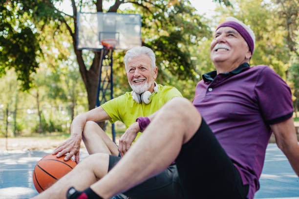 istock Two active senior men on basketball field taking a break from sport activity 1313168483