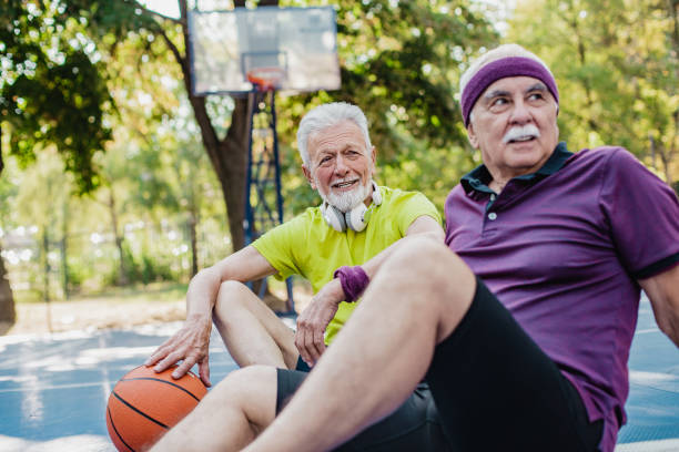 istock Two active senior men on basketball field taking a break from sport activity 1313168531