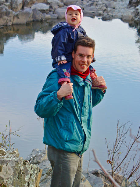 istock Father with daughter on shoulders 1313169994