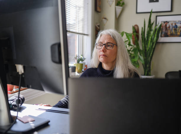 istock Mature woman working on computer from home 1313171206