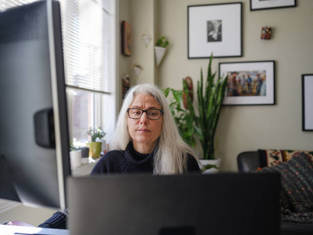 istock Mature woman working on computer from home 1313171397