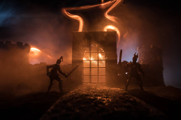 istock Medieval battle scene. Silhouettes of figures as separate objects, fight between warriors at night. Creative artwork decoration. Foggy background. 1313172911
