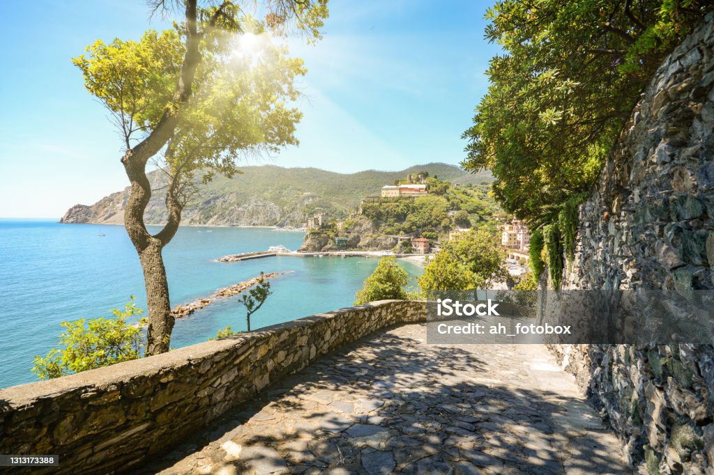 View from hiking trail to beautiful coastline and beach of mediterranean sea near village Monterosso al Mare in early summer, Cinque Terre Liguria Italy Europe Italy Stock Photo