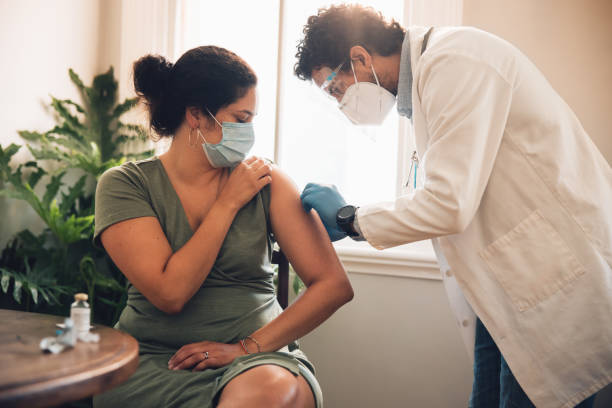 istock Woman getting covid-19 vaccination at home 1313176939