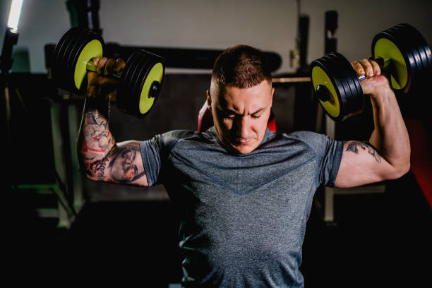 istock Working out with dumbbell in the gym 1313178142