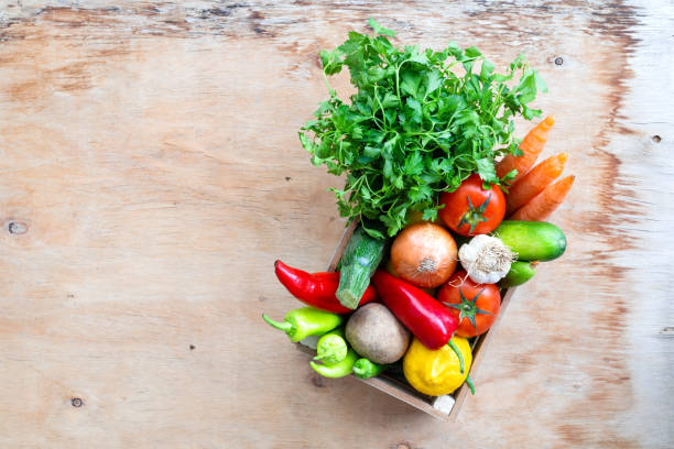 istock Fresh Vegetables in basket on wooden table. Top view. 1313178366