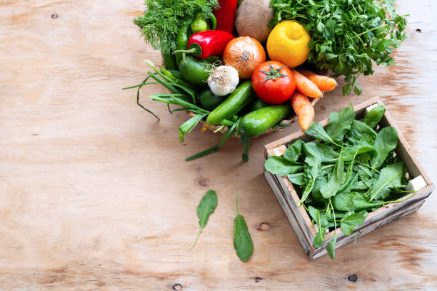 istock Fresh Vegetables in basket on wooden table. Top view. 1313178975