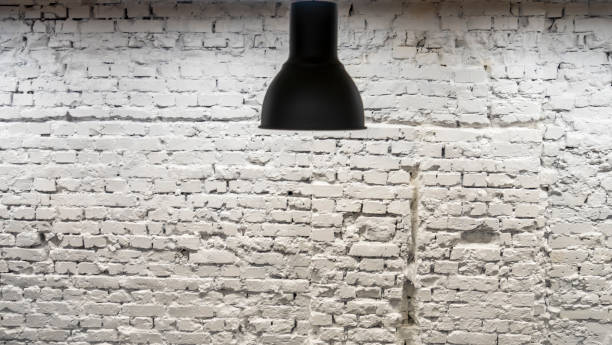 istock A black lamp in the interior against a white brick wall. Space for text. Image for design. 1313179411