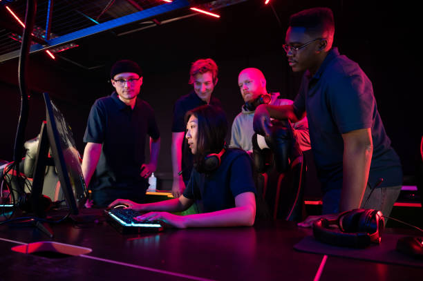 istock During a training session before the Dota 2 championship, the coach explains their strategy to the team, the girl plays at the computer 1313182651