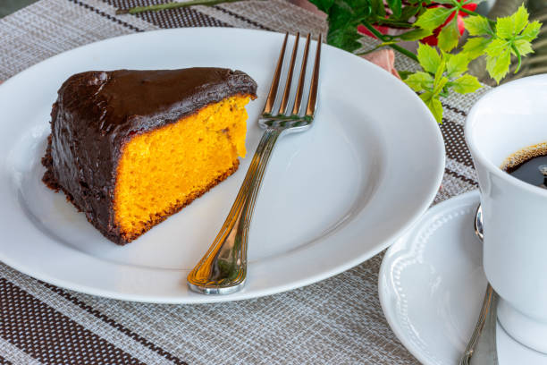 istock Carrot cake with chocolate icing, accompanied by a cup of coffee 1313183872