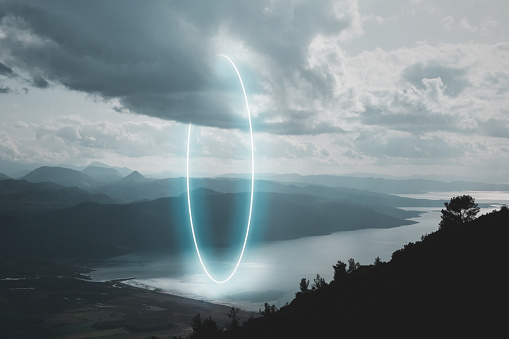 Mountain road landscape, stunning circle shape made with neon light inside the clouds