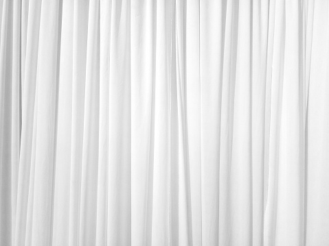 Soft white curtains are simple yet elegant for graphic design or wallpaper. Blurred cloth pattern with luxurious texture. Beautiful abstract background with smooth waves in a vintage style.