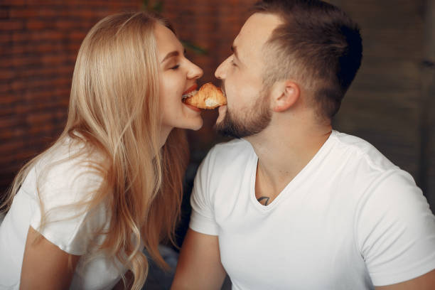 istock Couple sitting on a bed in a room 1313188585