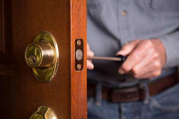 istock Worker or home owner installing or repairing new lock on doors. 1313191921