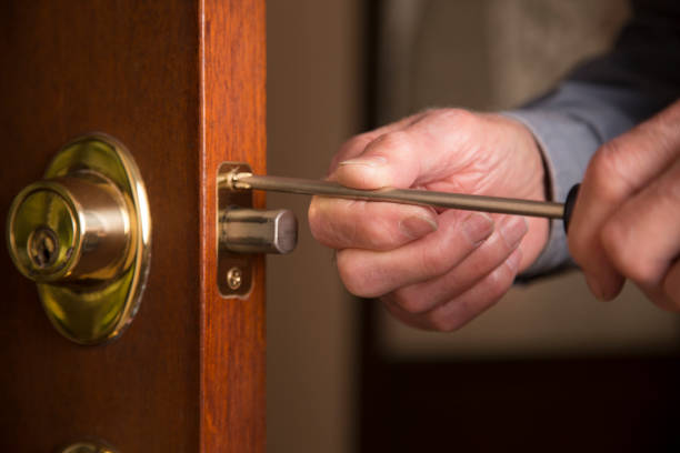 istock Worker or home owner installing or repairing new lock on doors. 1313191925
