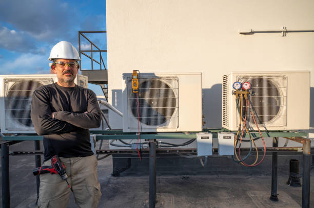 istock HVAC technician standing next to air conditioners outside 1313193088