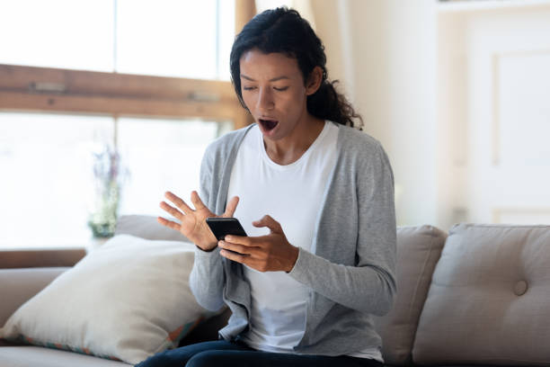 istock Confused young african ethnicity woman looking on cellphone screen. 1313193643