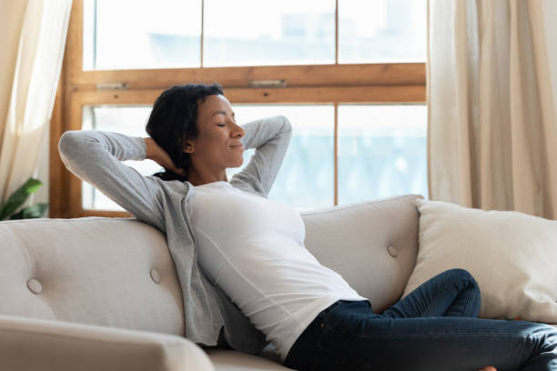 istock Tranquil young african american biracial woman relaxing on comfortable sofa. 1313193662