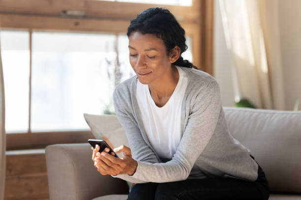 istock Smiling beautiful african american woman using smartphone. 1313193665