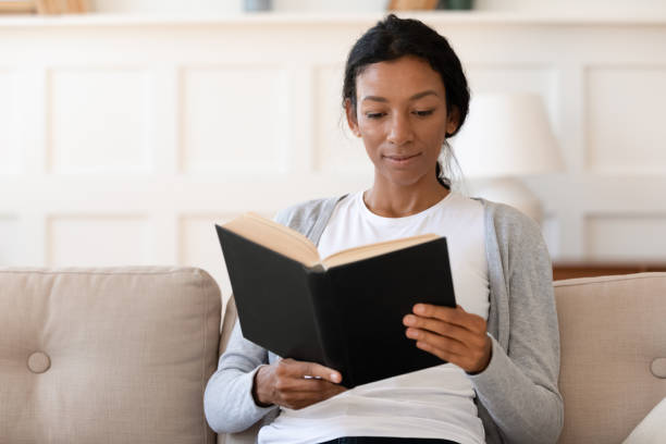istock Peaceful young mixed race woman reading paper book. 1313193678