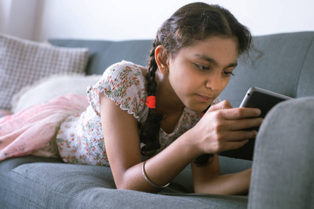 istock Ethnic middle school age girl using tablet computer at home 1313194113