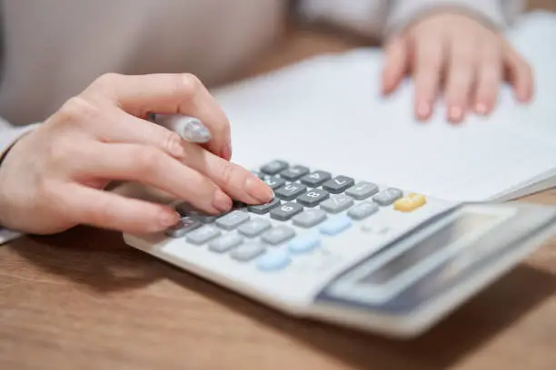 Asian woman reviewing household budget