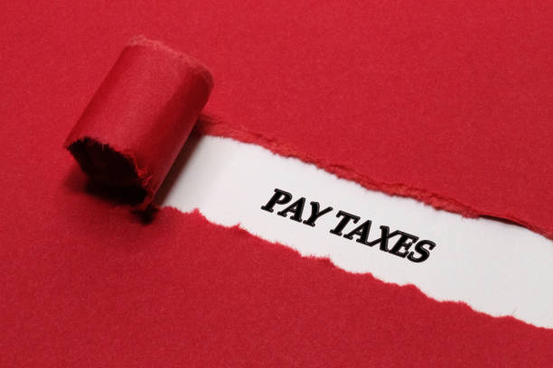 istock Pay Taxes Written Under Red Torn Paper 1313205111