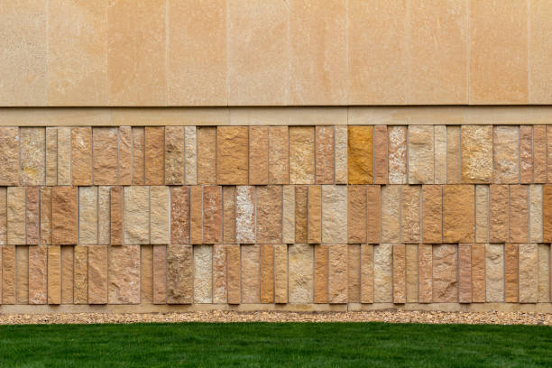 istock Modern tan shade natural limestone brick wall background with vertical aligned bricks 1313209902