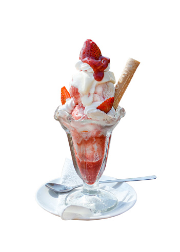 sweet dessert, refreshing homemade ice cream with cream and yogurt with strawberries and waffles in a glass bowl isolated on a white background