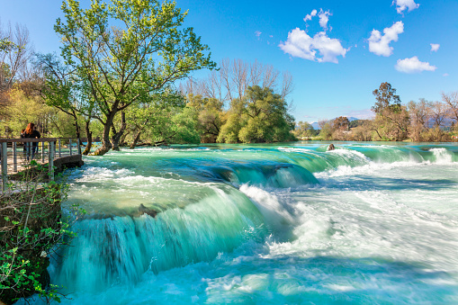 Beautiful natural landscape of Manavgat waterfall in national park on sunny spring day. Unique azure water color with splashes, Side, Antalya,Turkey. High quality photo