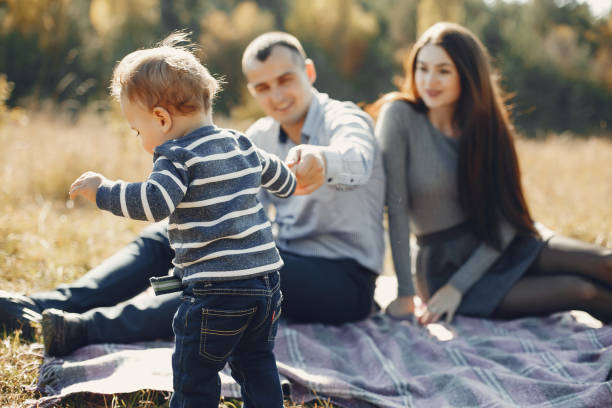 istock Cute family playing in a summer park 1313213110