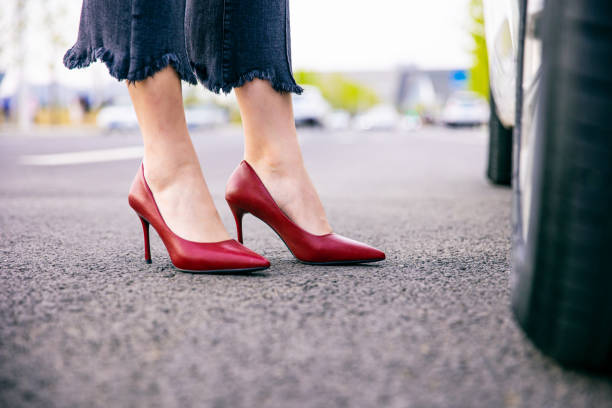 istock woman legs with high heels standing by car 1313215098