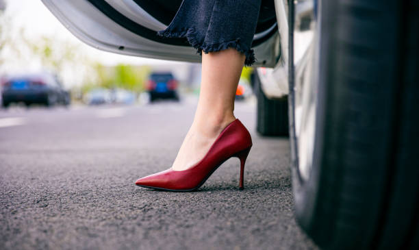 istock Young women legs disembarking car 1313215101