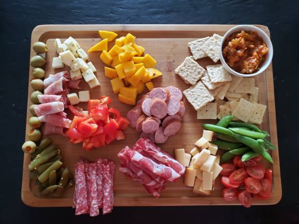 istock Charcuterie board of various meats, cheeses, fruit and pickles 1313216976