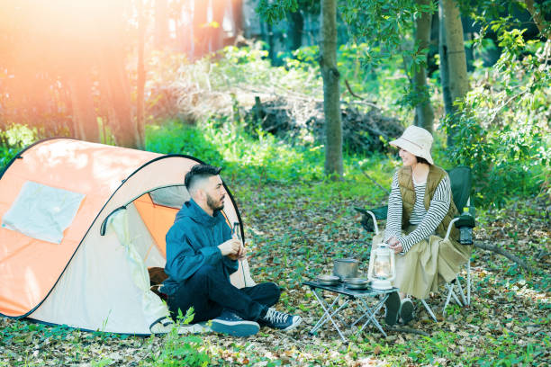istock Man and woman enjoying camping 1313218694