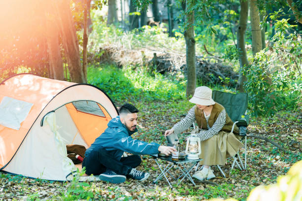 istock Man and woman enjoying camping 1313220463
