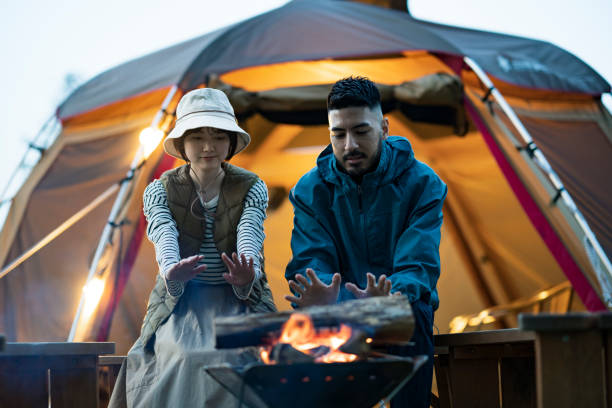 istock Man and woman enjoying a bonfire 1313220604