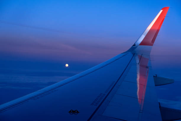 istock airplane window picture with sun on the horizon 1313221742