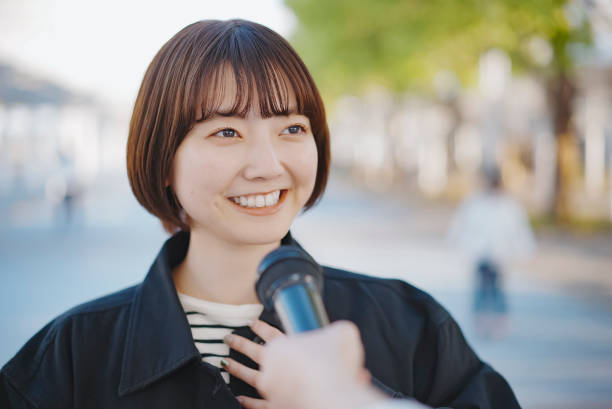 istock Young woman interviewed on the street 1313222761