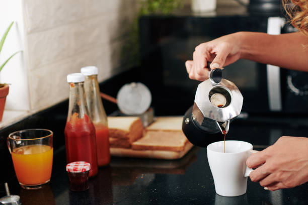 istock Woman pouring coffee cup 1313222772